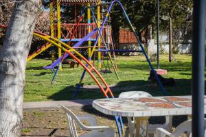 a playground with a colorful slide in a park at Piscoyaku Apart-Amplio parque con cancha de padel, voley y futbol in Potrero de los Funes