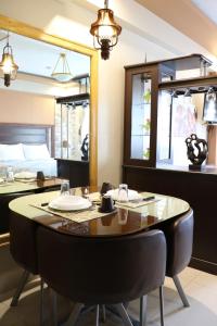 a dining room with a table and a bed at One Palm Tree Villas MANILA in Manila