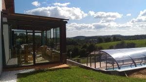 a building with a view of a farm with a tent at Gite des 3 bouleaux in Robelmont