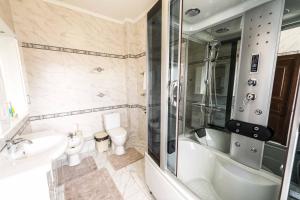 a bathroom with a tub and a toilet and a sink at Adler in Astana +55 photos