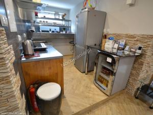 a kitchen with a stove and a refrigerator at Willa polne wzgórza in Krynica Zdrój