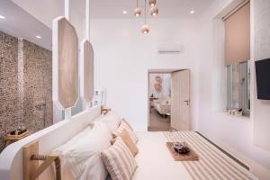 a living room with white walls and white pillows at Madonna del Mare in Chania