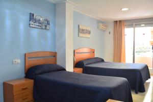 Postel nebo postele na pokoji v ubytování Hotel L'Escala