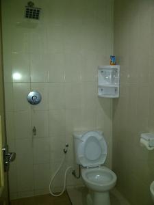 a small bathroom with a toilet and a sink at Ndalem Suratin Guesthouse in Yogyakarta