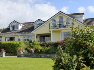 a yellow house with a yard at Oakfield in Kenmare