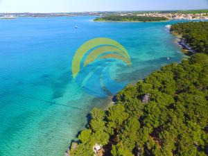 an aerial view of a paraglider flying over the ocean at Apartments 770 in Medulin