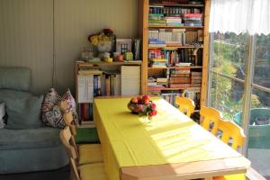 a dining room with a yellow table with fruit on it at Appartements della Schiava in Bad Kleinkirchheim