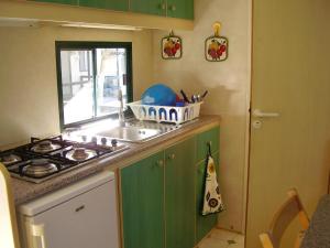a kitchen with a sink and a stove at Camping Village Riviera in Numana
