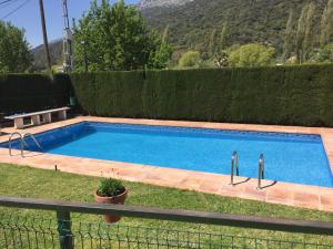 a swimming pool in a yard next to a fence at Casas San Cristóbal by CasaTuristica in Jimera de Líbar