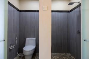 a bathroom with a white toilet in a stall at Semabu Hills Hotel Nusa Penida in Nusa Penida