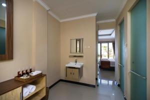 
a bathroom with a sink, toilet and a mirror at Semabu Hills Hotel Nusa Penida in Nusa Penida
