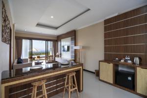 a hotel room with a bar with stools in it at Semabu Hills Hotel Nusa Penida in Nusa Penida