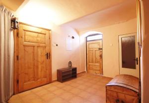 a room with two wooden doors and a table at Ubytovani U Lavky in Suchovršice