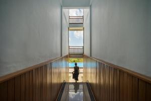 a person walking down an escalator in a building at Semabu Hills Hotel Nusa Penida in Nusa Penida