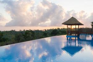 a swimming pool with a gazebo on top of it at Semabu Hills Hotel Nusa Penida in Nusa Penida