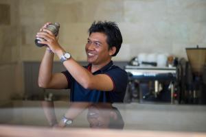 a man taking a picture with a camera at Semabu Hills Hotel Nusa Penida in Nusa Penida