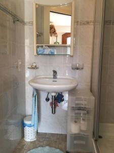 a bathroom with a sink and a mirror at Casa Fiorella in Locarno