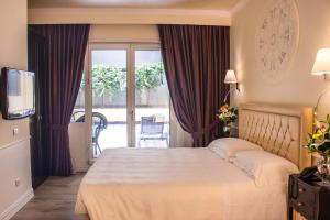 Postel nebo postele na pokoji v ubytování Hotel Patavium