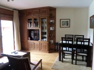 a living room with a dining room table and chairs at Apartamento Jardines del Sella in Cangas de Onís