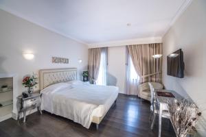Postel nebo postele na pokoji v ubytování Hotel Patavium