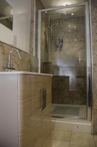 a shower with a glass door in a bathroom at The Sun Inn in Penrith