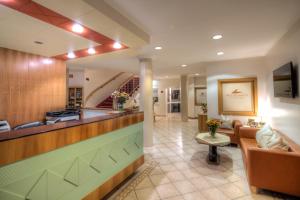 a lobby of a hotel with a waiting area and a counter at Hotel Weidenhof in Klagenfurt