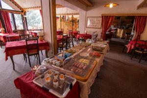 a restaurant with a buffet of food on tables at Hotel Adret in Les Deux Alpes