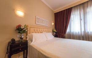 Postel nebo postele na pokoji v ubytování Hotel Patavium