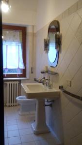 a bathroom with a sink and a mirror and a toilet at Casa Della Nonna in Radicofani +35 photos