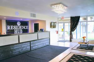 a lobby with a reception desk and a television at Residence Hub Inn and Suites in Marianna