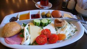 a plate of food with cheese and vegetables on a table at Ekol Hotel in Istanbul