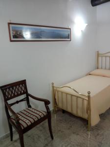 a bedroom with a bed and a chair at B&B House S. Ferdinando in Naples