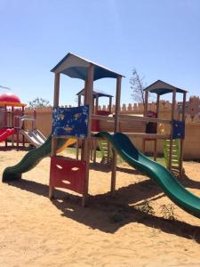 a playground with a slide in the sand at Al Kawtar in Mohammedia