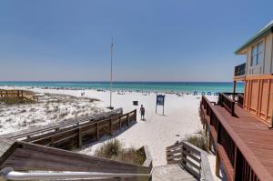 a beach with a building and people on the beach at Beachside Inn in Destin