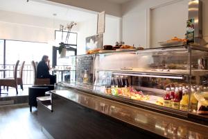a restaurant with a buffet line with food on it at Hotel Alexander in Mänttä