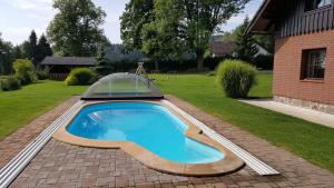 a swimming pool with a dome on top of a yard at Apartmany chaloupka in Tanvald