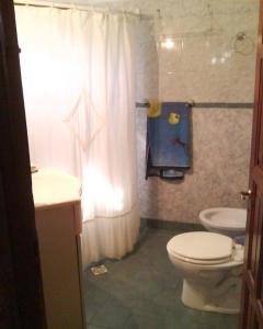 a bathroom with a white toilet and a sink at Angeluz Paso De La Patria in Paso de la Patria