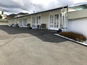 a row of benches on the side of a building at Picton House B&B and Motel in Picton