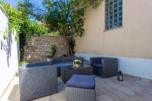 a patio with chairs and a table and a building at Monte & Paradiso in Pula