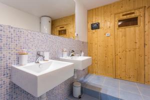 a bathroom with two sinks and a wooden door at Monte & Paradiso in Pula +29 photos