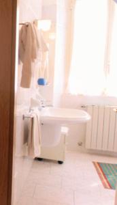 a bathroom with a white sink and a tub at Hotel Brisino in Stresa