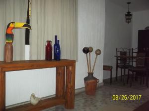 a wooden table with a parrot on top of it at La Casa del Chac in Mérida