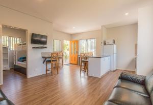 a living room with a couch and a kitchen at Riverview Tourist Park in Margaret River Town