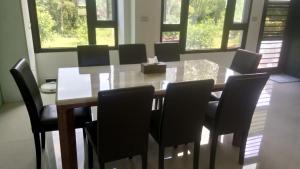a dining room table with chairs and a box on it at Kinmen 2 Home Puju Homestay in Jinhu