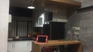 a kitchen with a red laptop on a table at Roemah Abdoe in Arau +37 photos