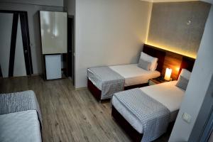 Postel nebo postele na pokoji v ubytování Laleli Hotel Izmir