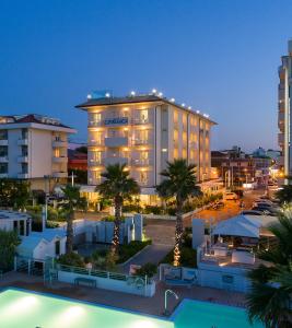 a hotel with a pool in front of a building at Hotel Ca' Bianca in Riccione