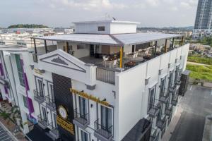 an overhead view of a white building with a balcony at Redpine Boutique Hotel in Skudai