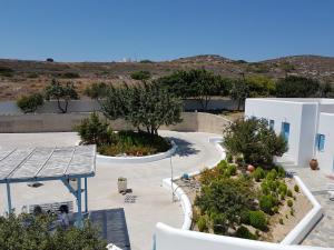 arial view of a courtyard with trees and a building at Sarakiniko Rooms in Adamantas