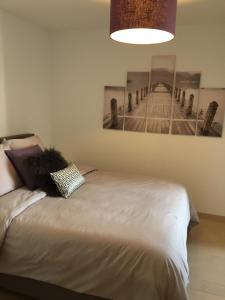 a bedroom with a bed with a picture of a pier at l'appart du 7 in Annecy